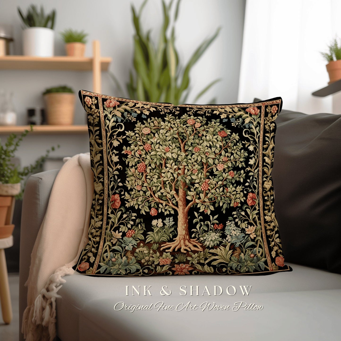 May include: A black pillow with a woven tapestry design of a tree with green leaves and pink flowers. The pillow has a gold border and the text "INK & SHADOW Original Fine Art Woven Pillow" is printed below it.