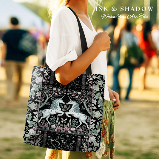 May include: A black tote bag with a woven tapestry design featuring two white unicorns in a forest setting. The bag has a black strap and the text "INK & SHADOW Woven Fine Art Tote" is printed on the top.