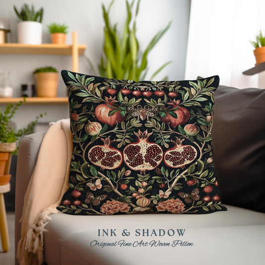 May include: A black throw pillow with a woven design featuring red pomegranates, green leaves, and butterflies. The pillow has the text "INK & SHADOW Original Fine Art Woven Pillow" printed on the bottom.