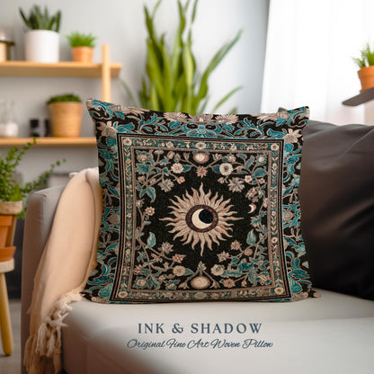 May include: A decorative throw pillow with a black background and a teal border. The pillow features a woven design of a sun and moon with floral accents. The text "INK & SHADOW Original Fine Art Woven Pillow" is printed below the pillow.