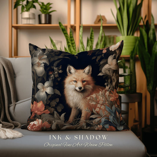 May include: A decorative throw pillow with a woven design featuring a fox in a floral setting. The pillow is dark blue with red, white, and green flowers. The text "INK & SHADOW Original Fine Art Woven Pillow" is printed on the bottom of the pillow.