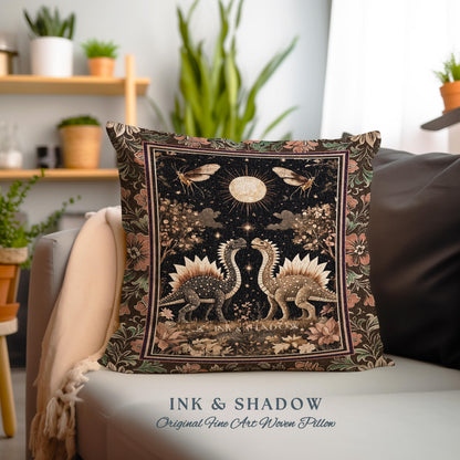 May include: A decorative pillow with a woven tapestry design featuring two dinosaurs facing each other under a full moon. The design is in shades of brown, gold, and black with a floral border. The text "INK & SHADOW Original Fine Art Woven Pillow" is printed below the pillow.