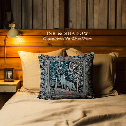 May include: A square woven pillow featuring a central illustration of a fox standing among stylized trees and flowers. The design uses a dark blue, teal, and cream color palette with a decorative border. The text INK & SHADOW Original Fine Art Woven Pillow is visible above the pillow.