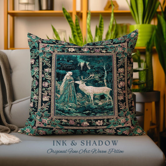 May include: A decorative pillow with a woven tapestry design featuring a woman in a forest with a white deer. The pillow has a black background with green and pink floral accents. The text "INK & SHADOW Original Fine Art Woven Pillow" is printed below the pillow.