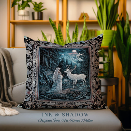 May include: A black and silver woven pillow with a tapestry design featuring a woman in a white gown and a white deer in a forest setting. The pillow has the text "INK & SHADOW Original Fine Art Woven Pillow" printed on the bottom.