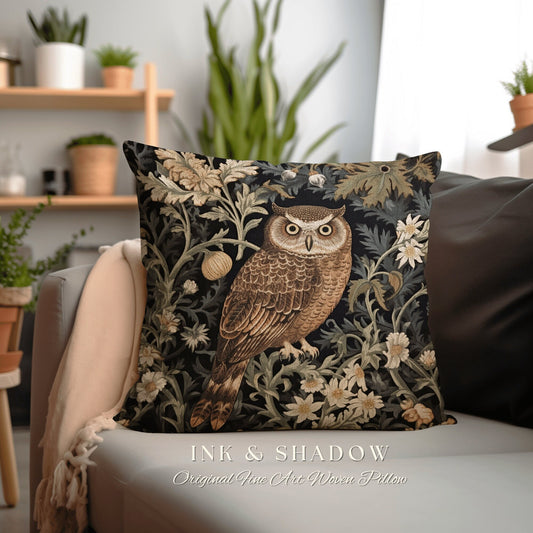 May include: A decorative throw pillow with a woven tapestry design featuring an owl perched in a floral pattern. The owl is brown and beige with large yellow eyes. The background is black with green and white floral details. The pillow has the text "INK & SHADOW Original Fine Art Woven Pillow" printed on the bottom.