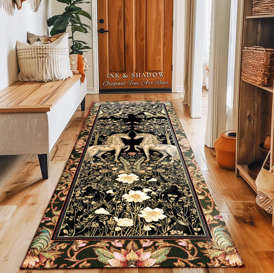 May include: A rectangular black rug with a floral and unicorn design. The rug features a border with a floral pattern in shades of green, pink, and brown. The center of the rug has two white unicorns facing each other. The text "INK & SHADOW Original Fine Art Rugs" is visible.