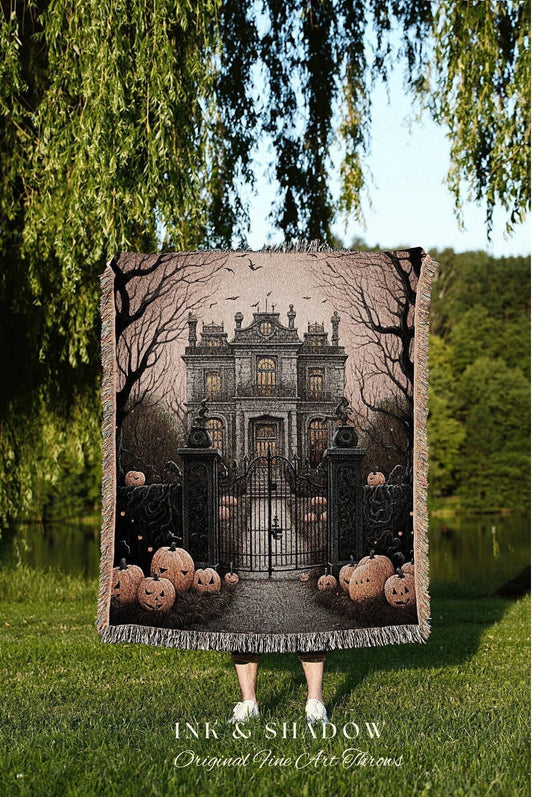 May include: A woven throw blanket featuring a spooky Halloween scene. The design includes a haunted mansion, pumpkins, and bare trees. The blanket has a fringed edge and the text "INK & SHADOW Original Fine Art Throws" at the bottom.