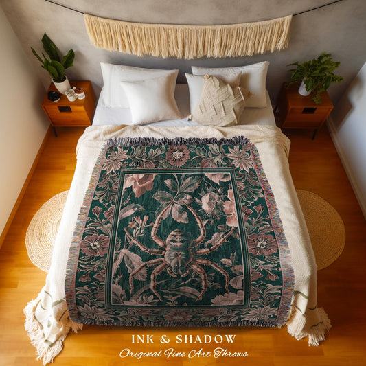 May include: A dark green throw blanket with a large spider and floral design. The blanket has a fringe border and is displayed on a bed with white bedding. The text "INK & SHADOW Original Fine Art Throws" is at the bottom.