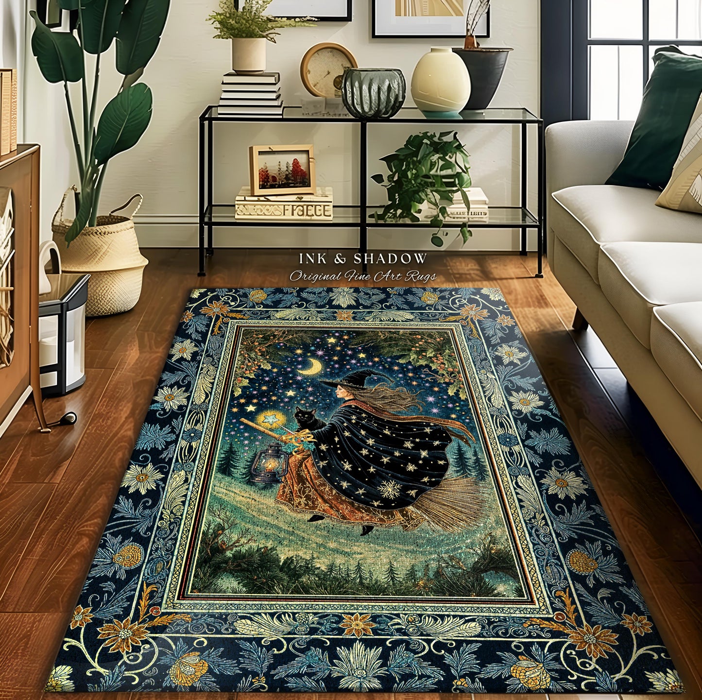 May include: A rectangular rug with a dark blue floral border and a central image of a witch flying on a broomstick under a starry night sky. The rug has the text "INK & SHADOW Original Fine Art Rugs".