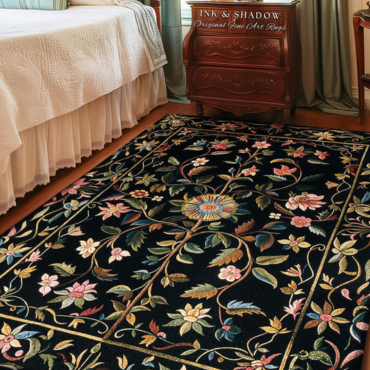 May include: Black rectangular rug with a floral design. The rug features a central floral medallion with blue, yellow, and pink petals, surrounded by a network of vines and flowers in various colors. The border is a gold color.