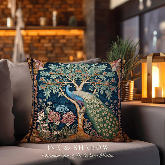 May include: A decorative throw pillow with a woven tapestry design featuring a peacock standing in a tree with flowers and leaves. The pillow is blue, green, and gold with the text "INK & SHADOW Original Fine Art Woven Pillow" at the bottom.