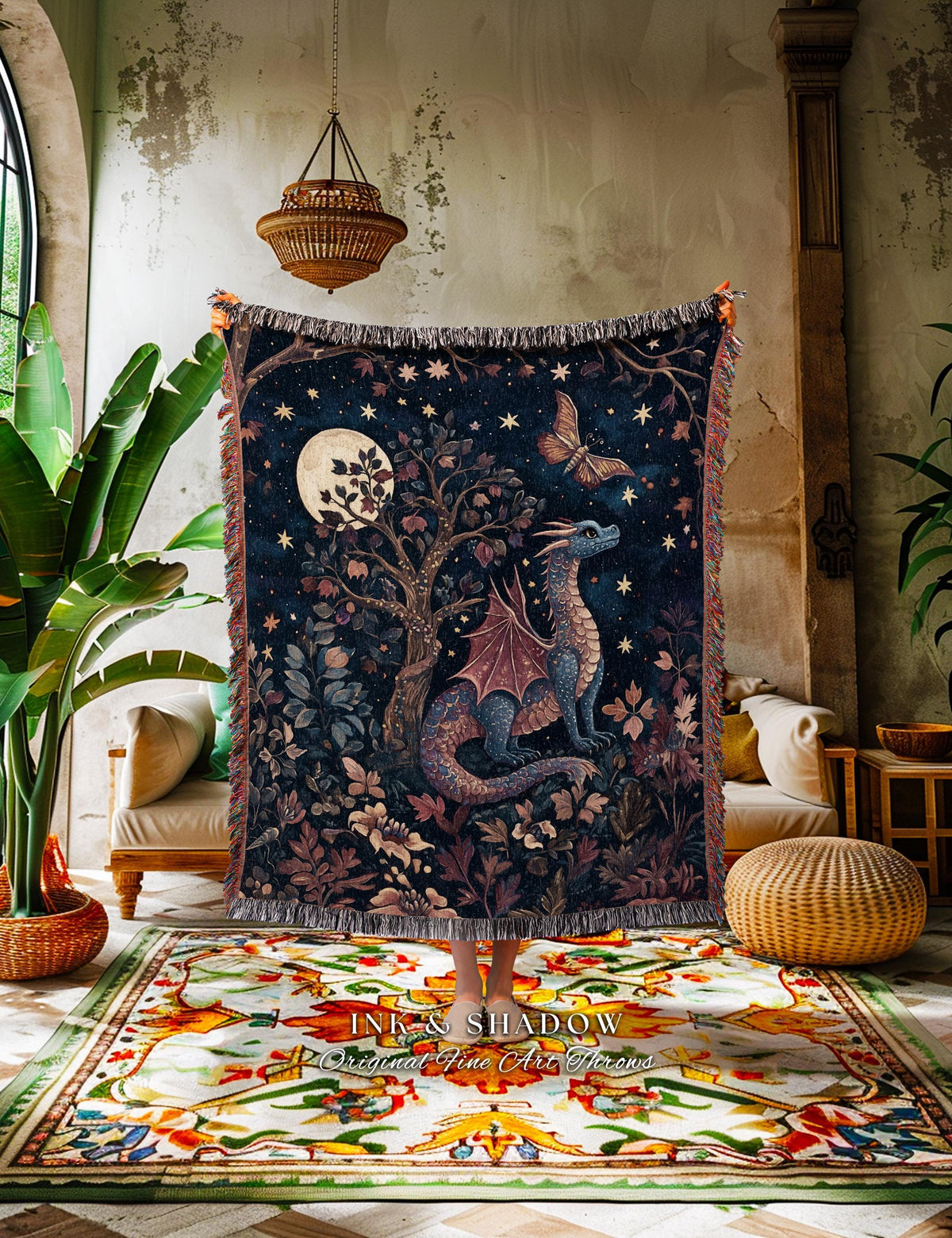 May include: A dark blue throw blanket featuring a dragon, butterfly, and tree design under a starry night sky. The blanket has a fringed edge and the text "INK & SHADOW Original Fine Art Throws" at the bottom.