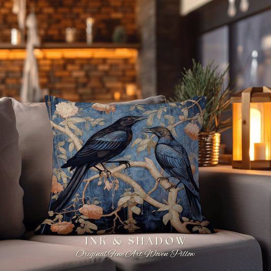 May include: A blue and gold woven pillow featuring two black birds perched on branches with pink flowers. The pillow has the text "Ink & Shadow Original Fine Art Woven Pillow" at the bottom.