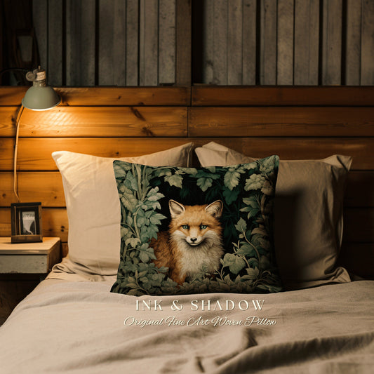 May include: A decorative pillow with a woven image of a red fox peeking out from behind green leaves. The pillow has the text "INK & SHADOW Original Fine Art Woven Pillow" printed on the bottom.