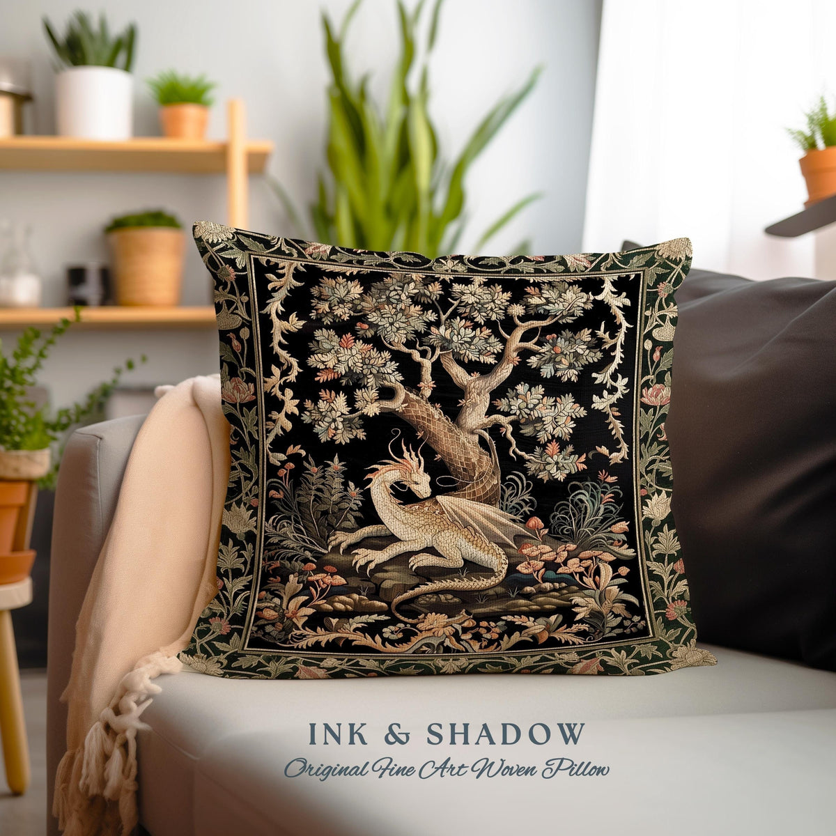 May include: Square decorative pillow with a black background featuring a detailed tapestry design. The tapestry depicts a white dragon resting beneath a tree with floral accents. The text "INK & SHADOW Original Fine Art Woven Pillow" is at the bottom.