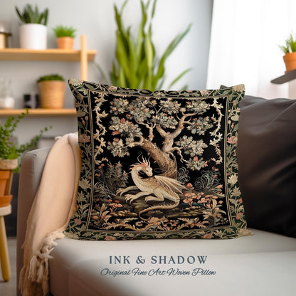 May include: Square decorative pillow with a black background featuring a detailed tapestry design. The tapestry depicts a white dragon resting beneath a tree with floral accents. The text "INK & SHADOW Original Fine Art Woven Pillow" is at the bottom.