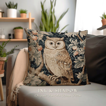 May include: A decorative throw pillow featuring a tapestry-style design of an owl perched on a branch in a forest setting. The owl is white with brown markings and has large, yellow eyes. The background is a dark blue with green and brown foliage.