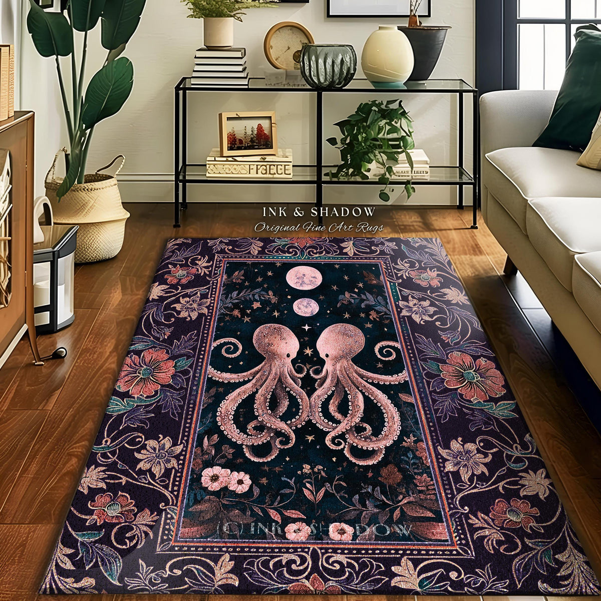 May include: A rectangular area rug with a dark background featuring two pink octopuses facing each other. The rug has a floral border with pink and purple flowers. The text "INK & SHADOW Original Fine Art Rugs" is visible.