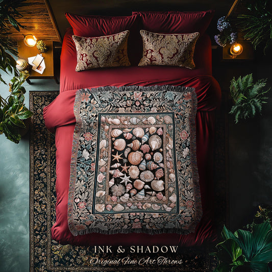 May include: A bed with red bedding, two patterned pillows, and a decorative throw blanket. The throw features a seashell design in the center, framed by floral patterns. The text "INK & SHADOW Original Fine Art Throws" is at the bottom.