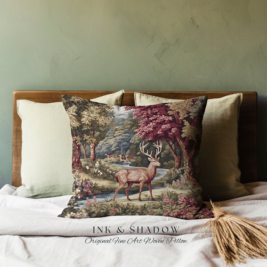 May include: A decorative throw pillow with a woven tapestry design featuring a deer in a forest setting. The pillow has a dark background with shades of green, brown, and red. The text "INK & SHADOW Original Fine Art Woven Pillow" is printed below the image.