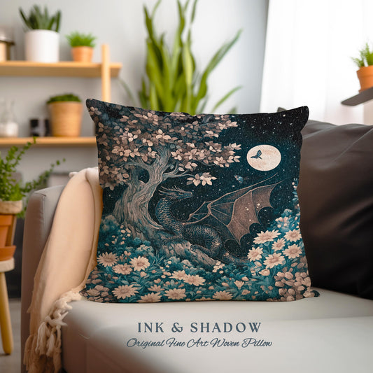 May include: A decorative pillow featuring a woven design of a dragon in a forest setting with a full moon and a butterfly. The pillow has a teal, blue, and brown color scheme and the text "INK & SHADOW Original Fine Art Woven Pillow".