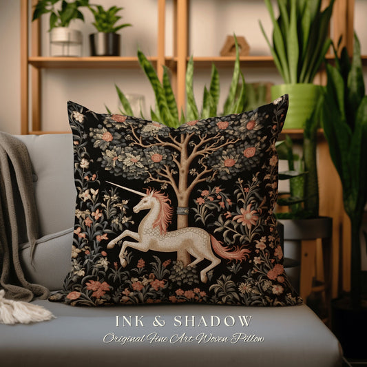 May include: A black and white woven pillow featuring a unicorn running through a forest scene. The pillow has a tapestry-like design with intricate details. The text "INK & SHADOW Original Fine Art Woven Pillow" is printed on the bottom of the pillow.