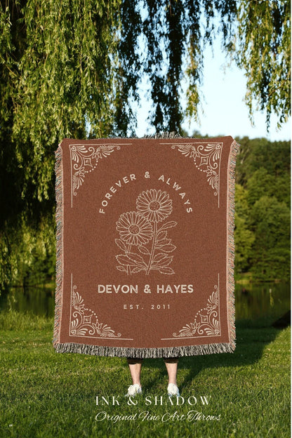 May include: A brown throw blanket with white fringe, featuring the text "FOREVER & ALWAYS" and "DEVON & HAYES EST. 2011". The blanket has a floral design and decorative corner elements. The brand name "INK & SHADOW" is at the bottom.