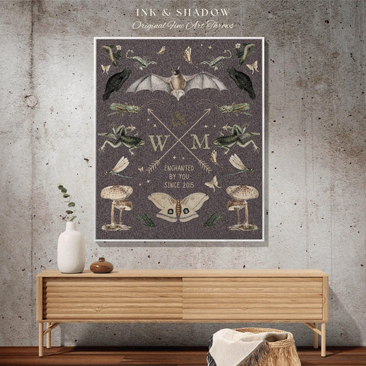 May include: A framed art print with a dark gray background featuring illustrations of a bat, crows, frogs, mushrooms, and butterflies. The text "INK & SHADOW Original Fine Art Throws" is at the top, and "ENCHANTED BY YOU SINCE 2015" is at the bottom.