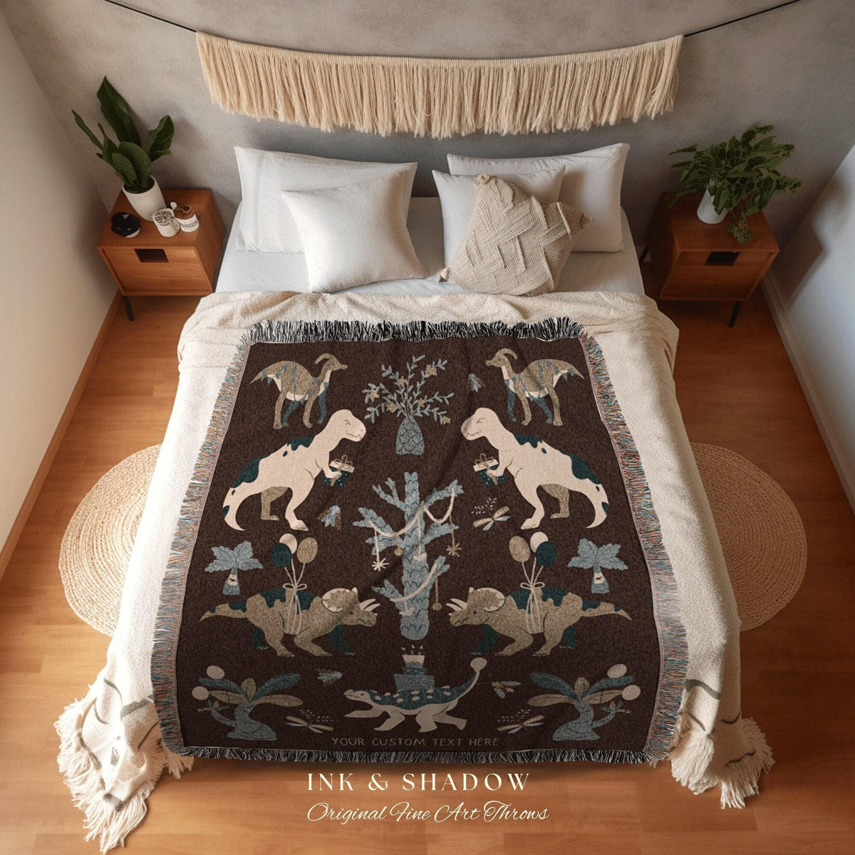 May include: A brown throw blanket with a dinosaur design. The blanket features various dinosaur illustrations in beige and gray, with a fringe border. The text "INK & SHADOW Original Fine Art Throws" is at the bottom.