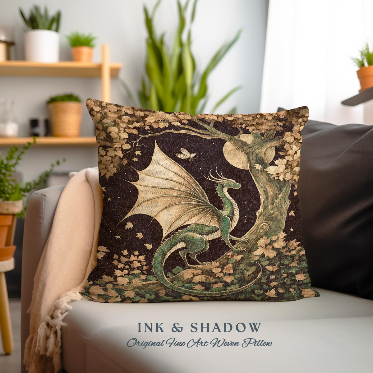May include: A green dragon with wings outstretched sits on a tree branch in a forest scene. The dragon is surrounded by leaves and a full moon shines in the night sky. The pillow is made of woven fabric and has the text "INK & SHADOW Original Fine Art Woven Pillow" at the bottom.